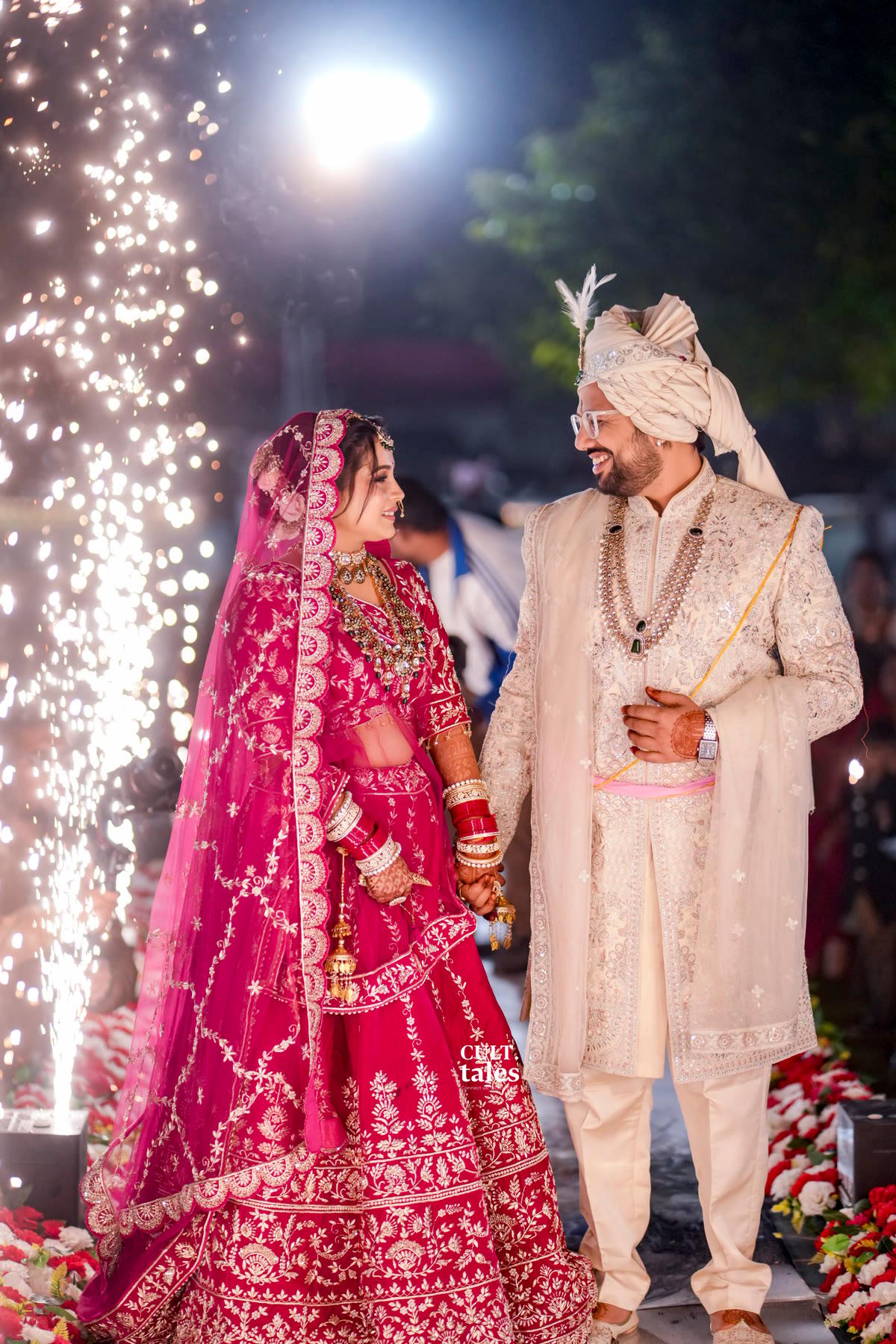 The bride and groom smiling under falling sparks